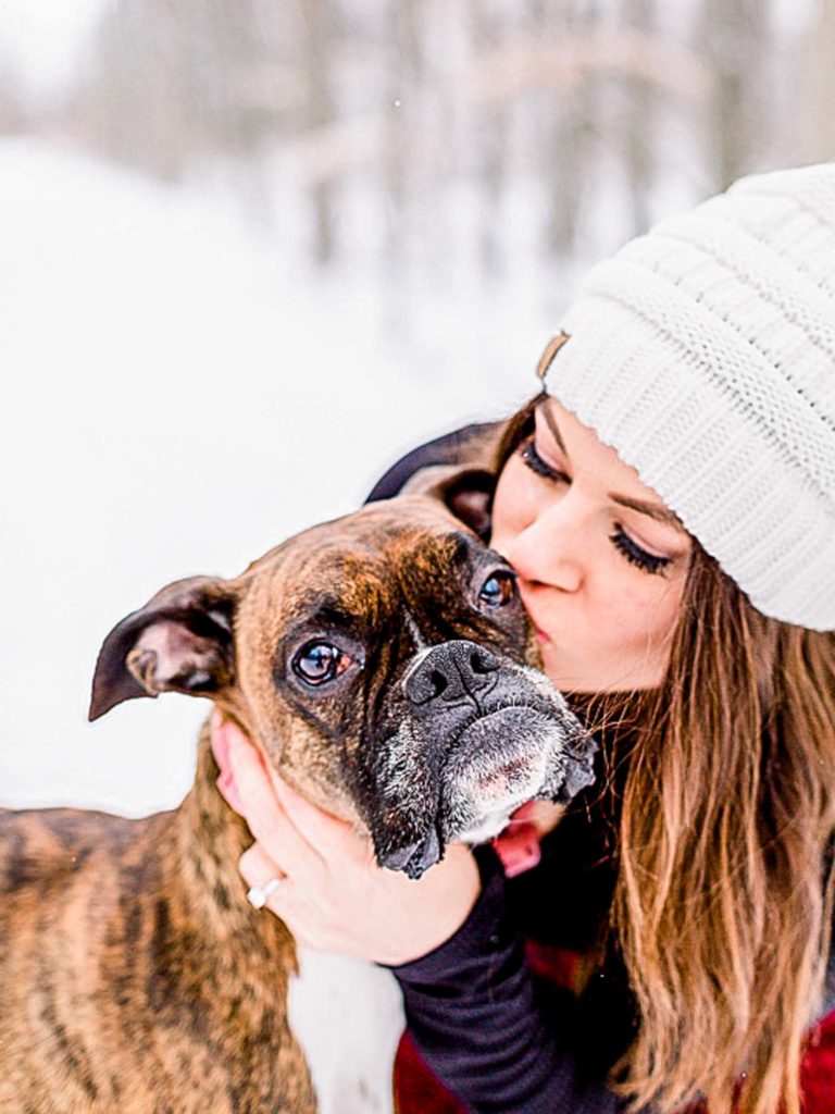 Frankenmuth winter engagement session with dog mom kissing her dog