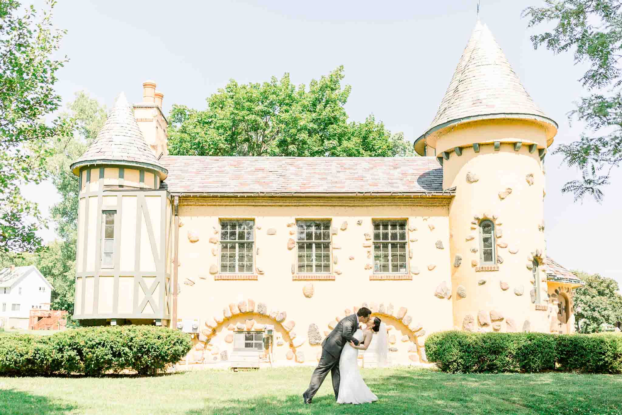 Groom kissing bride dip at Michigan Castle Wedding at Curwood Castle
