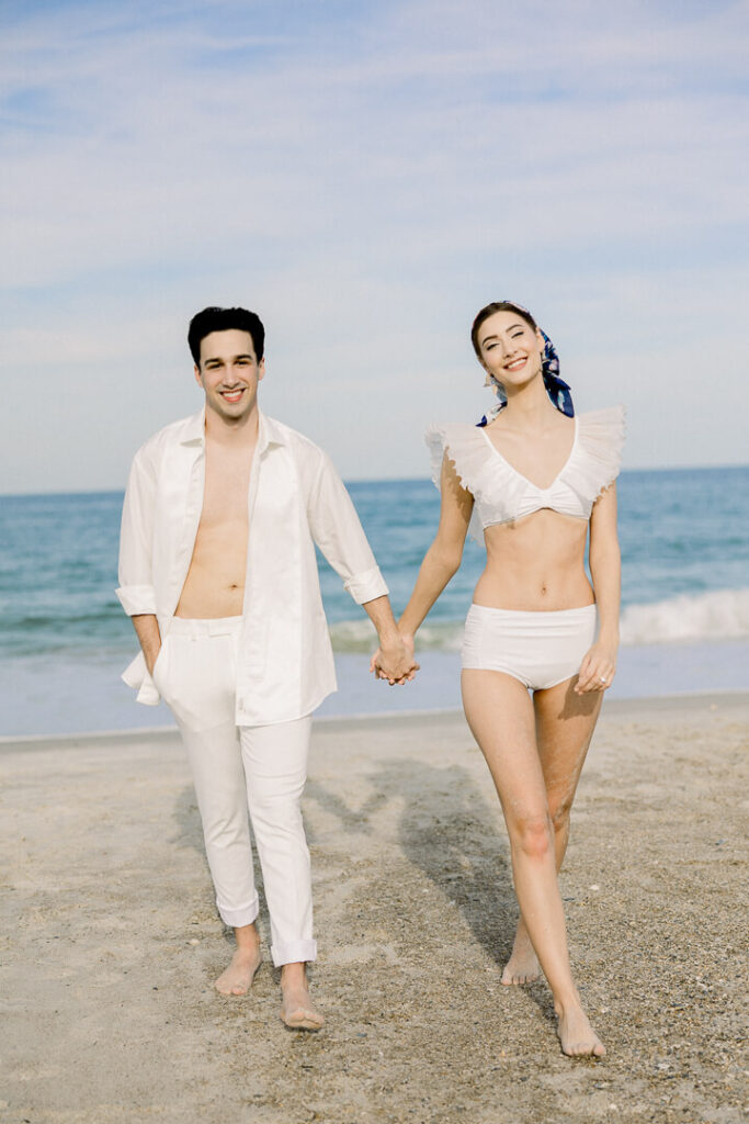 beach engagement session couple holding hand