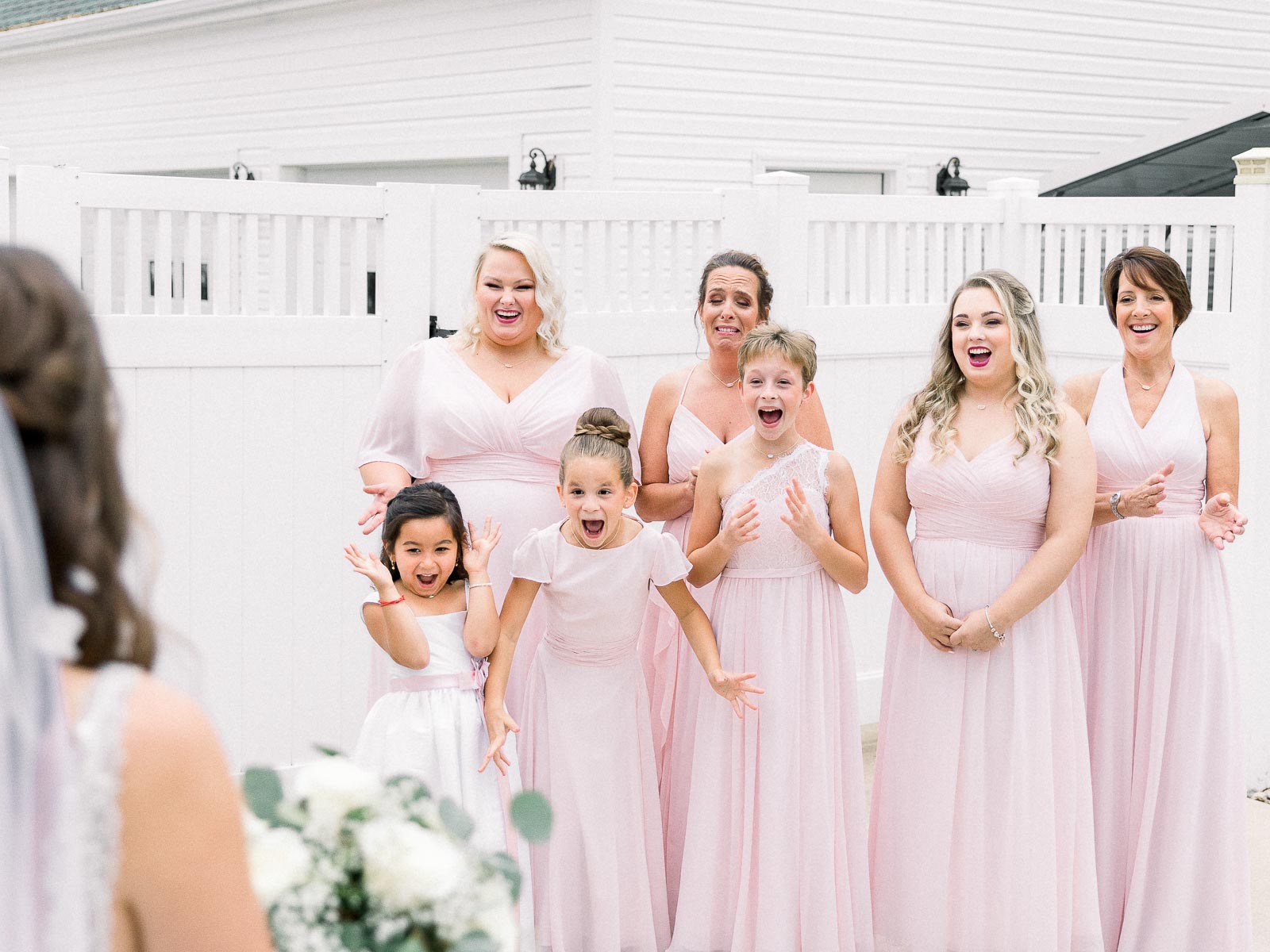 Bridesmaids in pink bridesmaids dress first look with the bride by Chinling Photography