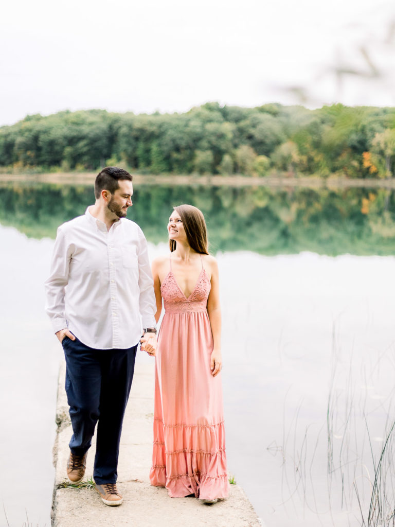 couple holding hands and walking engagement session seven lakes state park