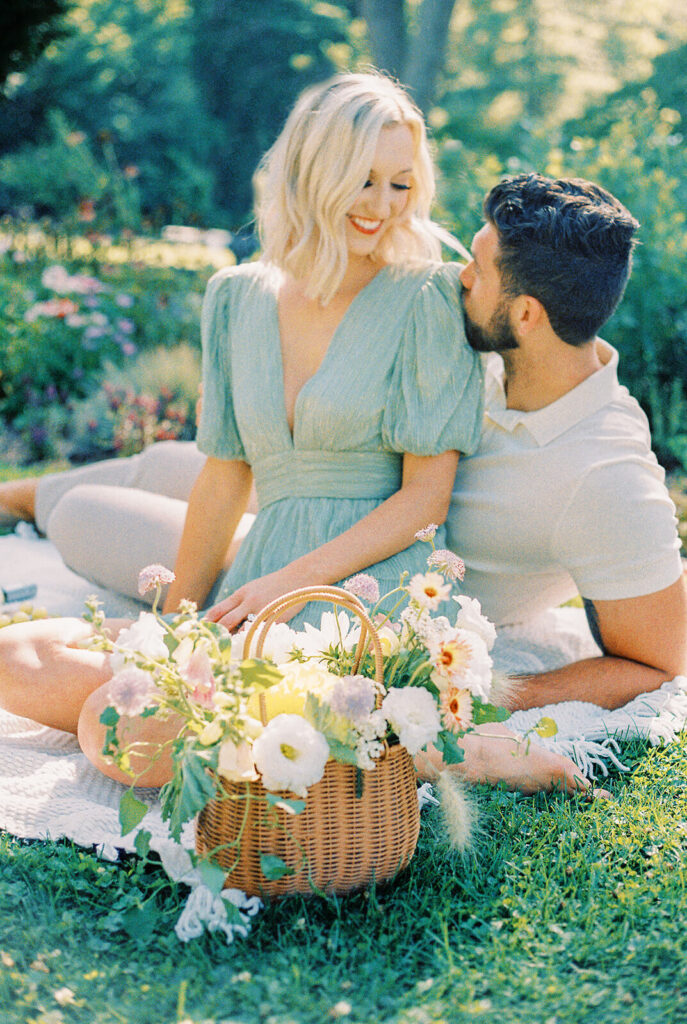 couple picnic on a blanket with flower basket