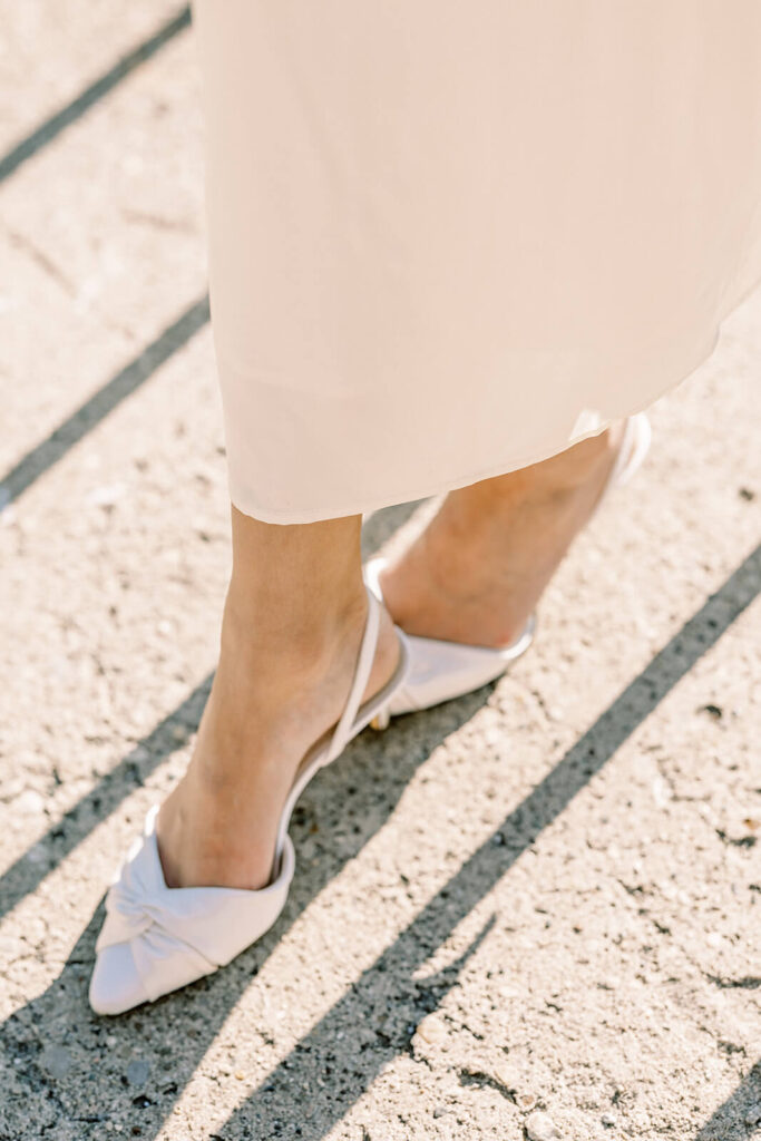 bride wearing Nina Shoes white bridal shoes