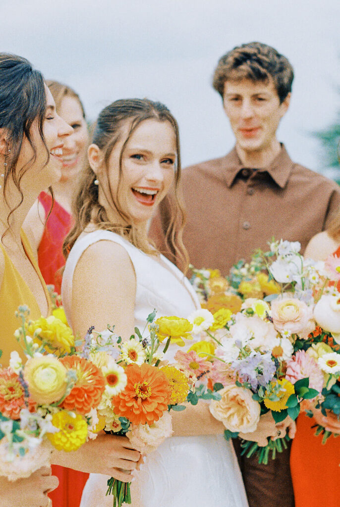 bride with bridesmaids and bridesman in multi-colored dresses0