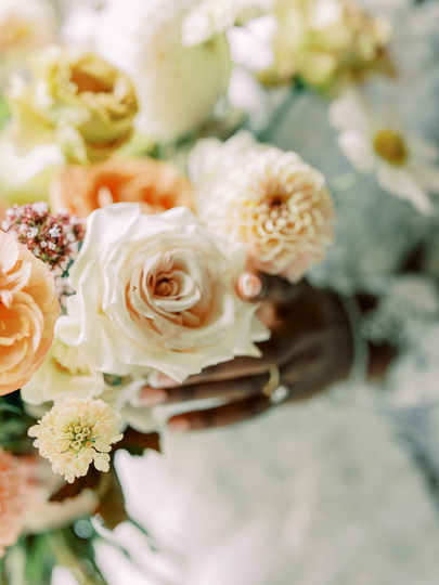 Bride touching flower bouquet 