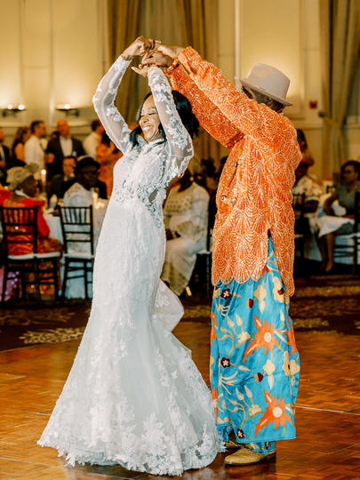 Nigerian bride and dad dancing in traditional attire at wedding reception
