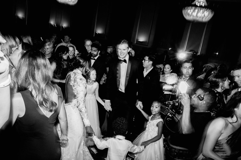 Bride and groom dancing with guests during reception at Saint John's resort