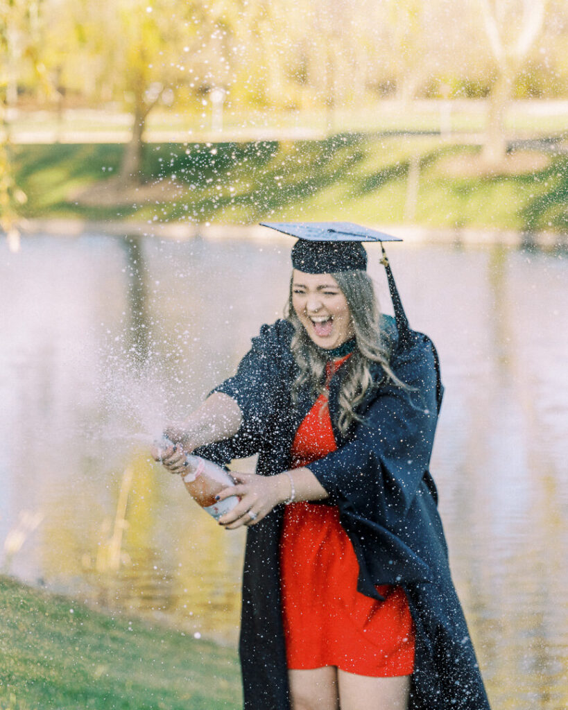 Saginaw Valley State graduates in cap and gown popping champagne2