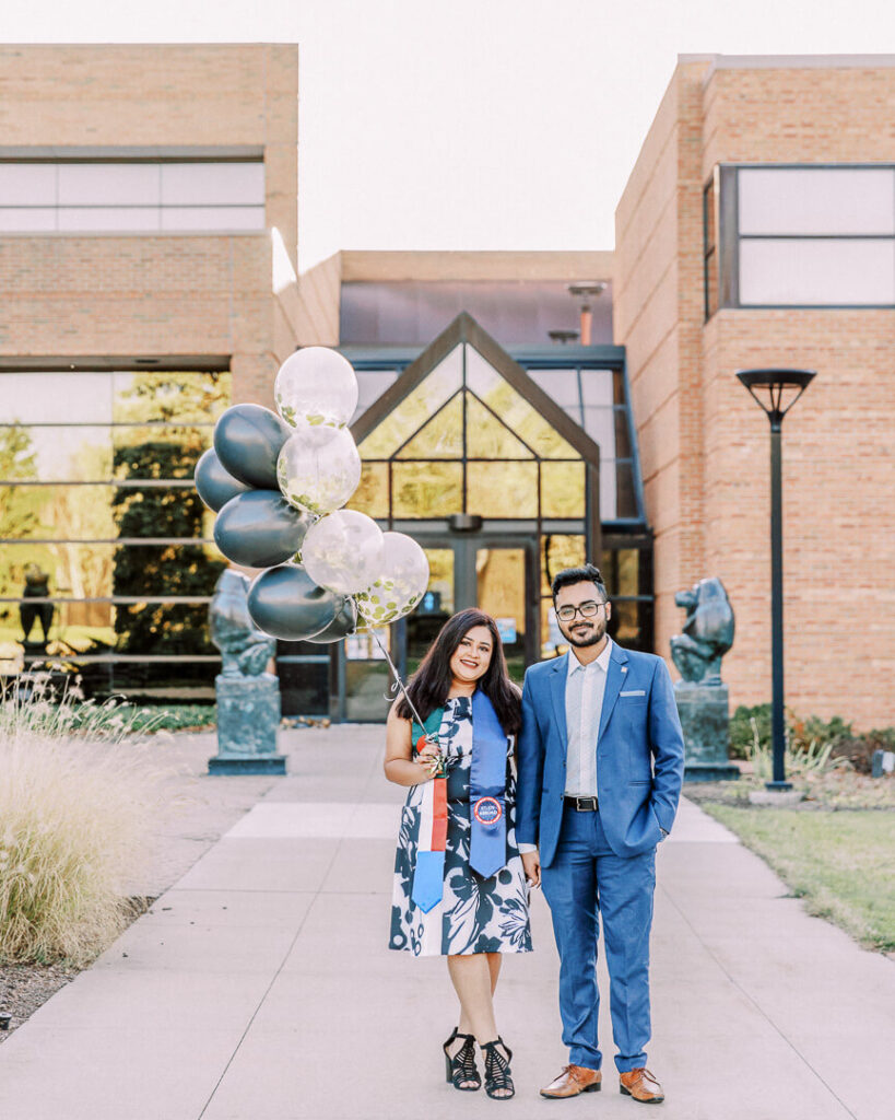 multicultural couple engagement session on campus with balloons0