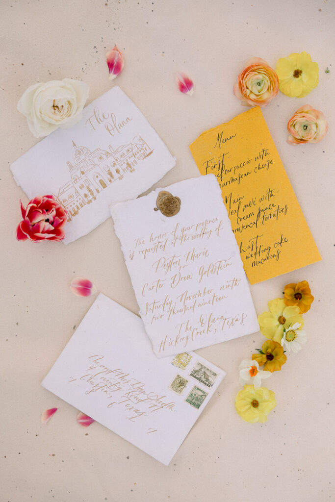 Coral Reef color wedding invitation flatlay with orange adn yellow flowers0