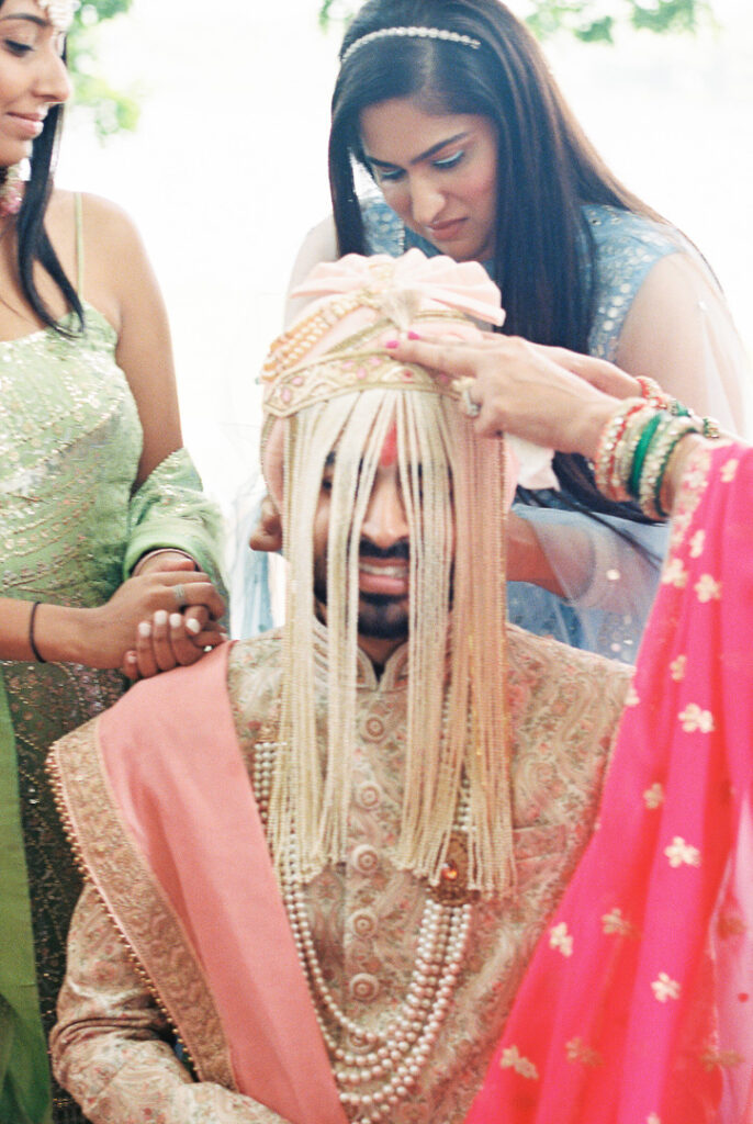 Indian wedding groom tying the Sehra