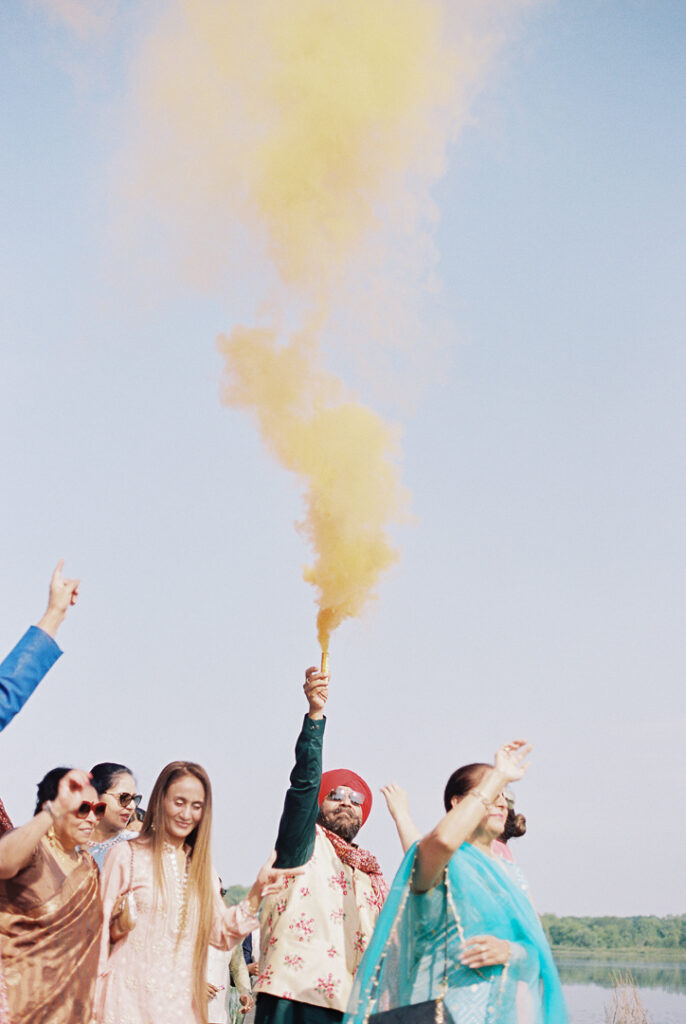 Hindu wedding colorful smoke bomb during baraat ceremony