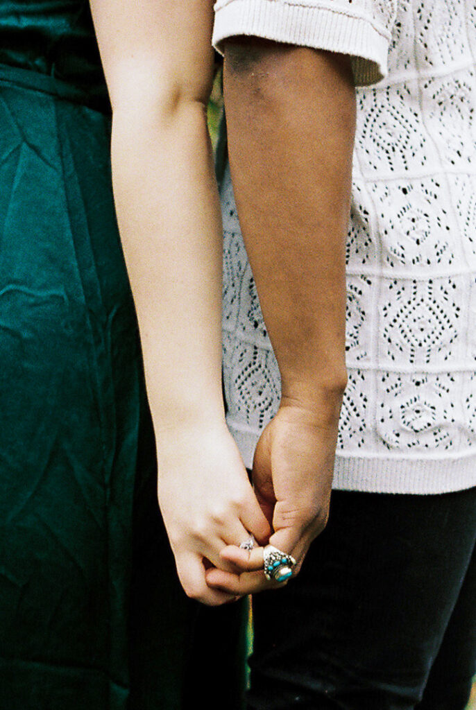 Michigan film engagement session multicultural couple holding hands