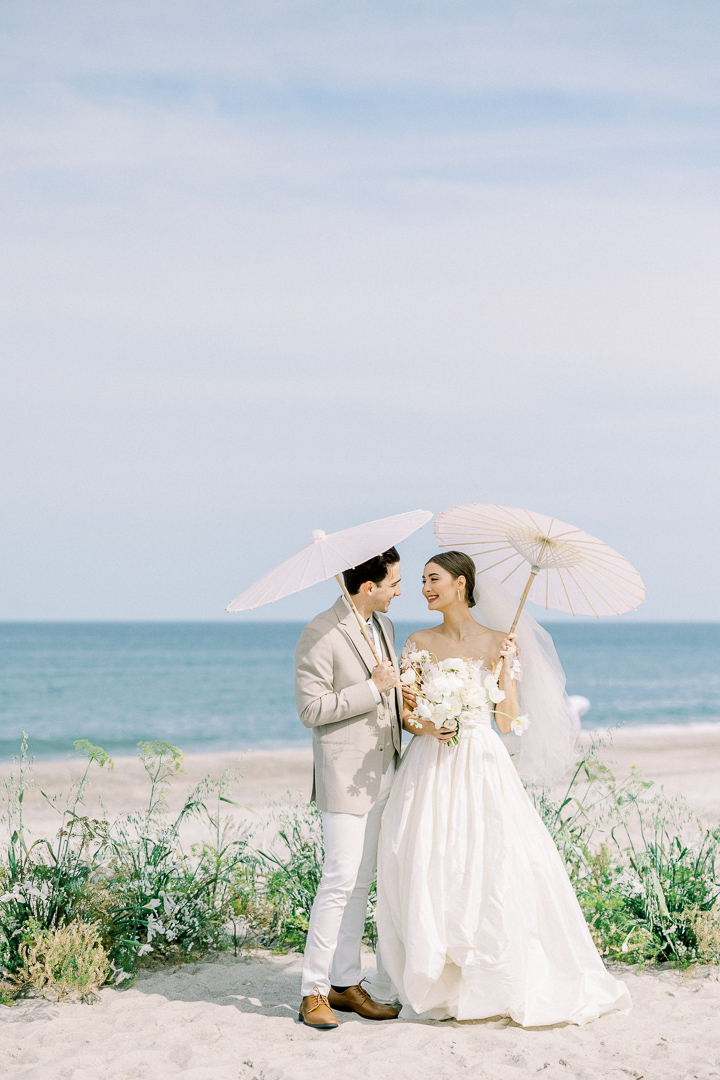 beach wedding ceremony bride and groom with parasol