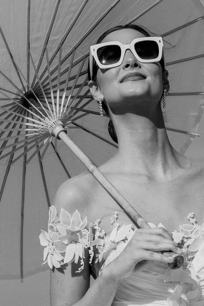 bridal portrait with white paper parasol and white vintage sunglasses0