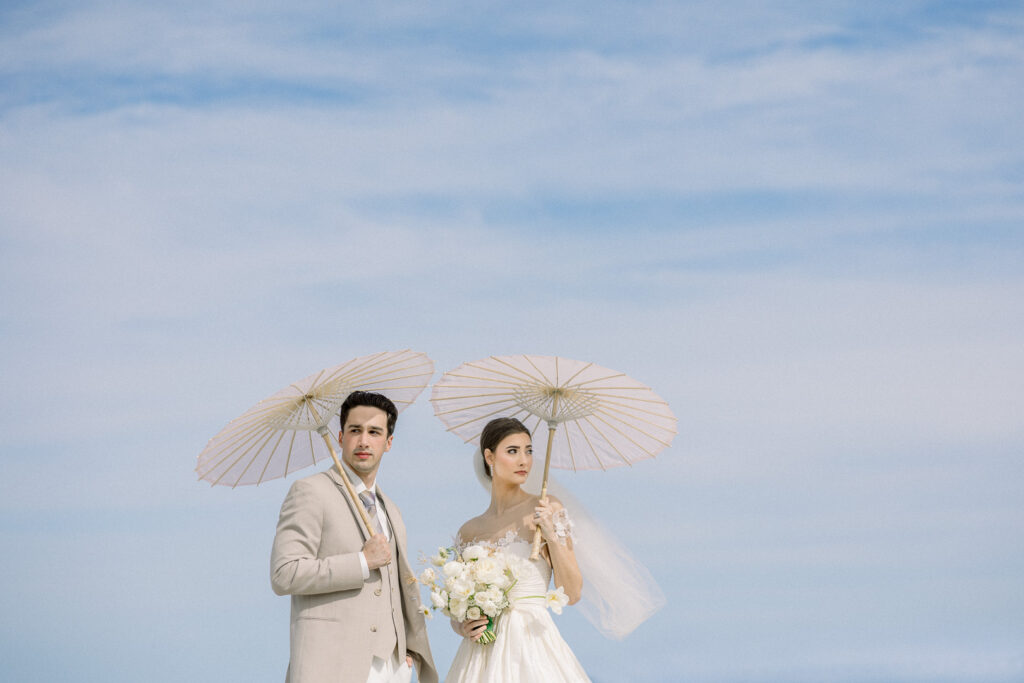 bride and groom portrait with paper parasol at Omni Amelia Island Resort beach wedding1