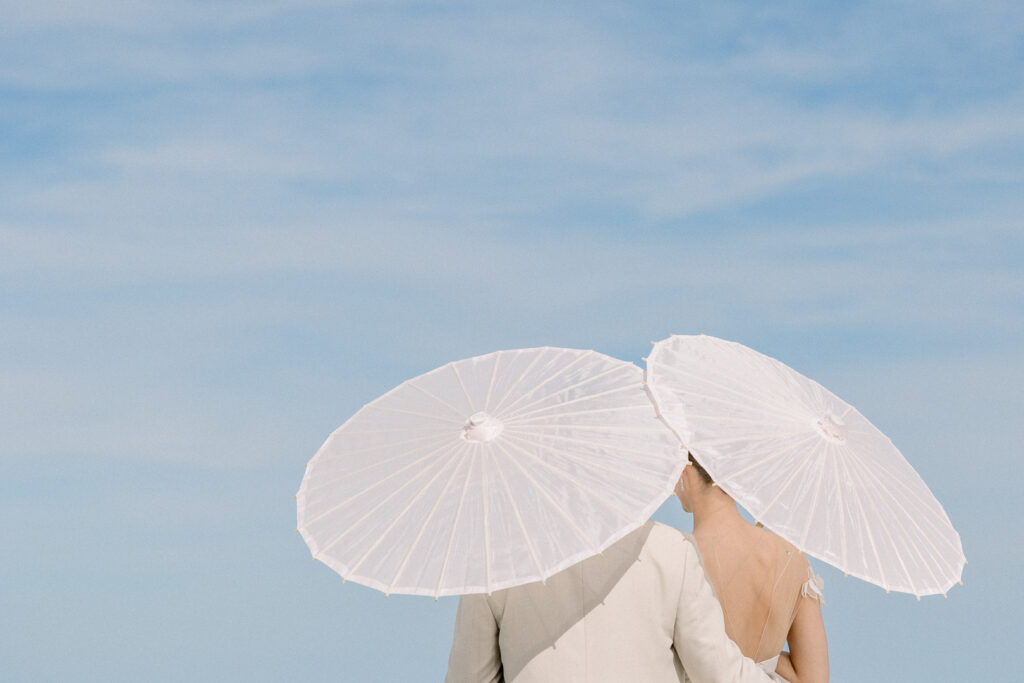 bride and groom portrait with paper parasol at Omni Amelia Island Resort beach wedding10