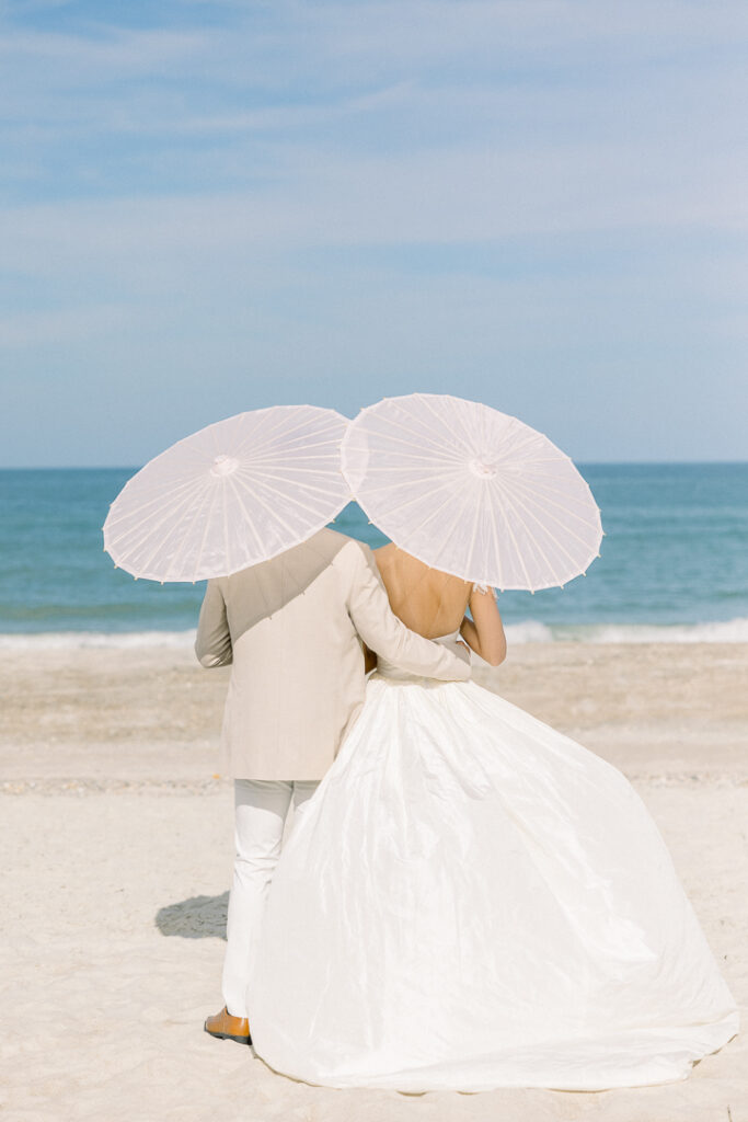 bride and groom portrait with paper parasol at Omni Amelia Island Resort beach wedding11