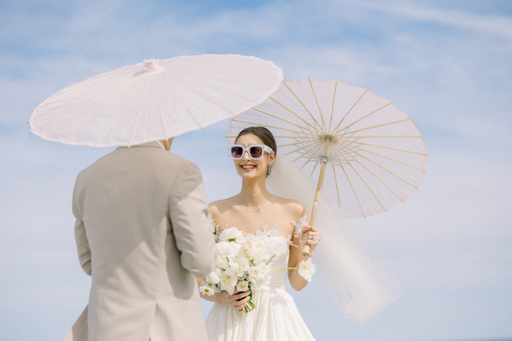 bride and groom portrait with paper parasol at Omni Amelia Island Resort beach wedding3