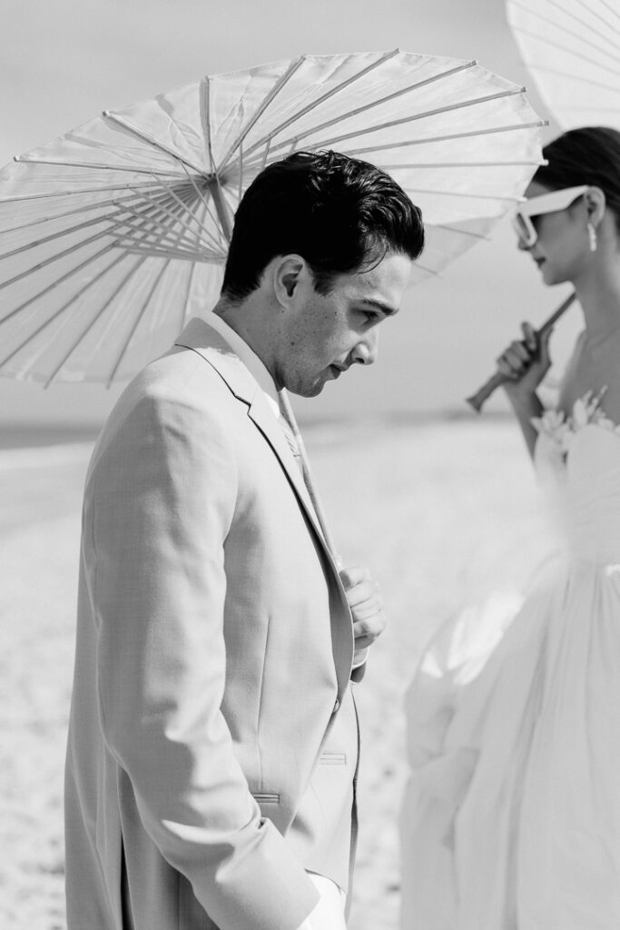 bride and groom portrait with paper parasol at Omni Amelia Island Resort beach wedding8