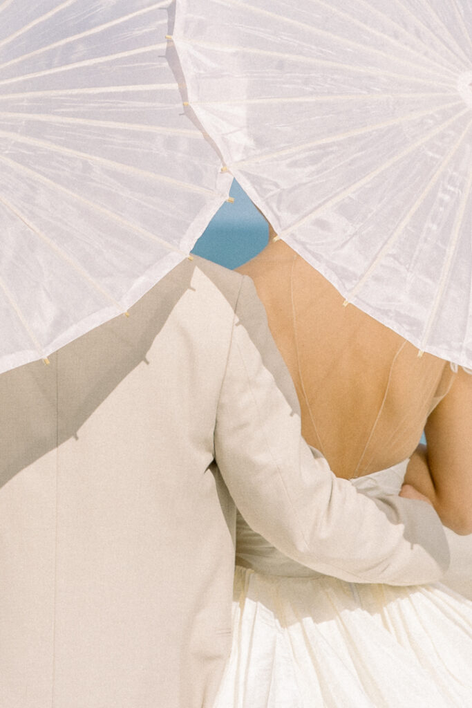 bride and groom portrait with paper parasol at Omni Amelia Island Resort beach wedding9