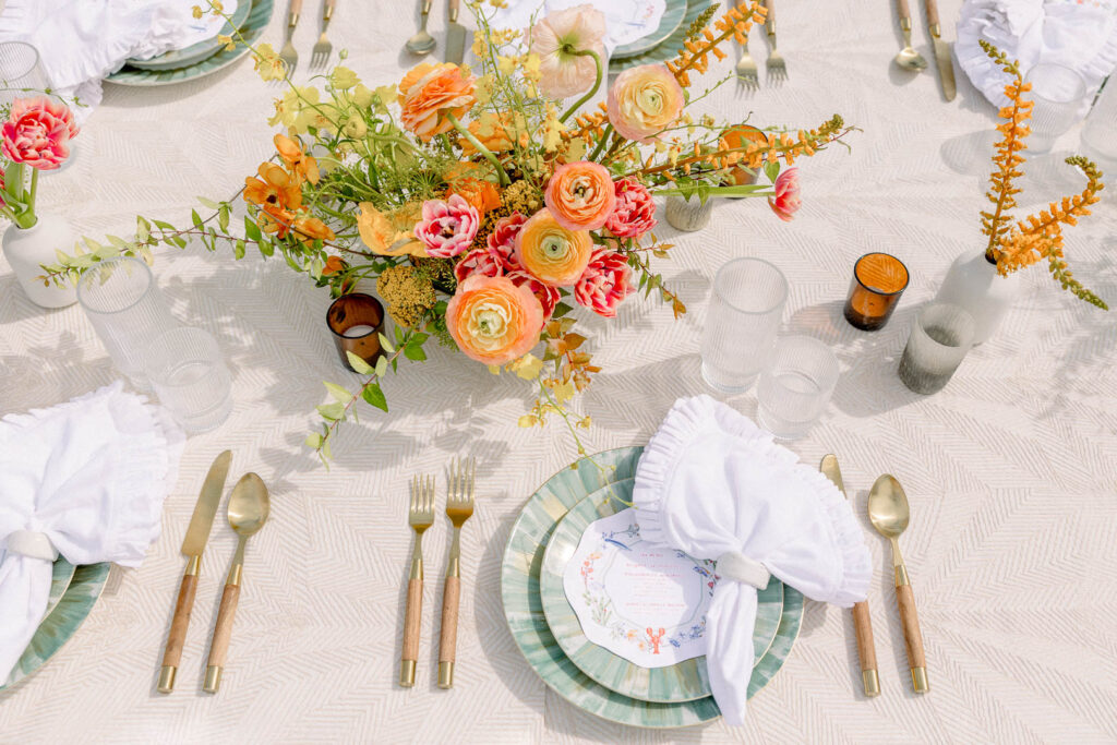 summer floral centerpiece in orange and peach reception decor